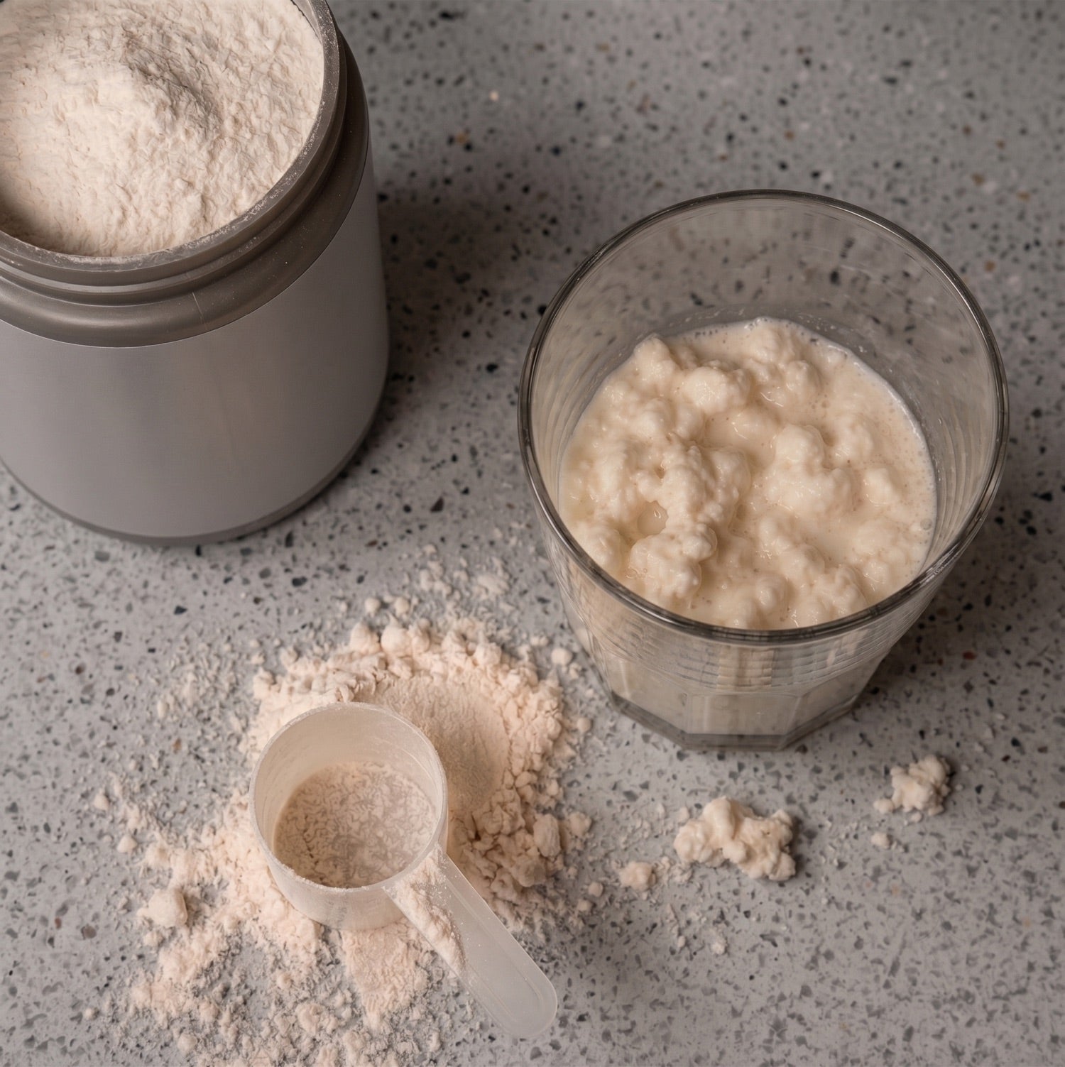 Colostrum powder clumping in a glass — the format that resists mixing